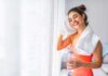 Doctors Flip Post-Meal Exercise Playbook Woman wiping sweat with towel after workout