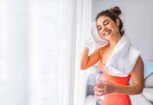 Doctors Flip Post-Meal Exercise Playbook Woman wiping sweat with towel after workout
