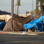 Street tents covered with tarps along a sidewalk