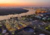 Benzene Nightmare in Niger Delta – WHO Limits Shattered Industrial oil refinery complex beside a river at dusk