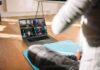 The No.1 Exercise To Lose Belly Fat In 2026 person on yoga mat watching a virtual workout class on a laptop
