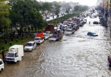 Flood Alerts Spark Nation-Wide Panic Flooded city street with stranded vehicles and traffic jam