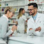 Pharmacist assists customer at pharmacy counter