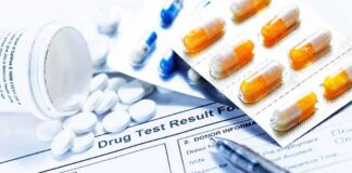 Drug test form with pills, capsules, and a pen