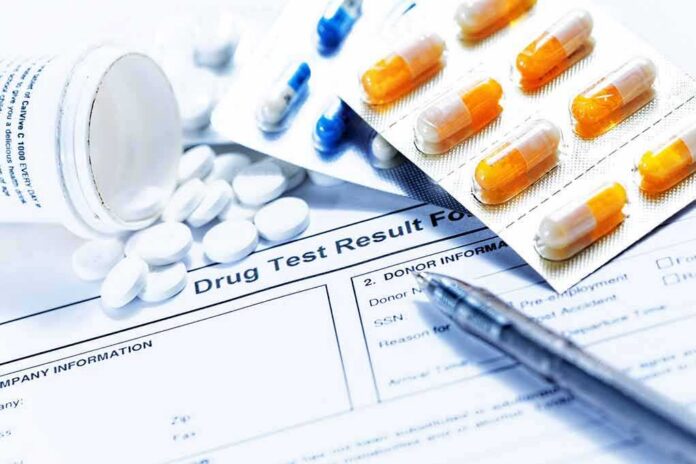 Drug test form with pills, capsules, and a pen