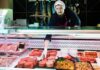 Imported Beef Flood: What’s Hiding In Labels? Butcher arranging meat patties in display case