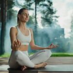 Woman meditating outdoors in a seated yoga pose