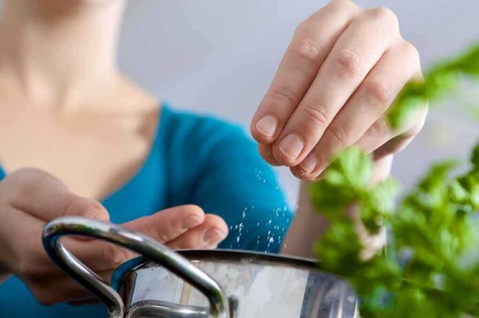 shutterstock_40316218 Person seasoning food with herbs from a pot