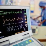 Patient monitor displaying vital signs in a hospital room