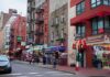 Early ZIP Code, Late Heart Damage City street with brick buildings, fire escapes, and busy storefronts