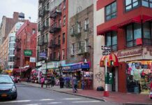 Early ZIP Code, Late Heart Damage City street with brick buildings, fire escapes, and busy storefronts