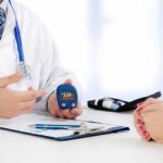 Silent Diabetes Speeds The Ovarian Clock doctor showing a blood glucose meter to a patient