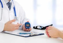 doctor showing a blood glucose meter to a patient