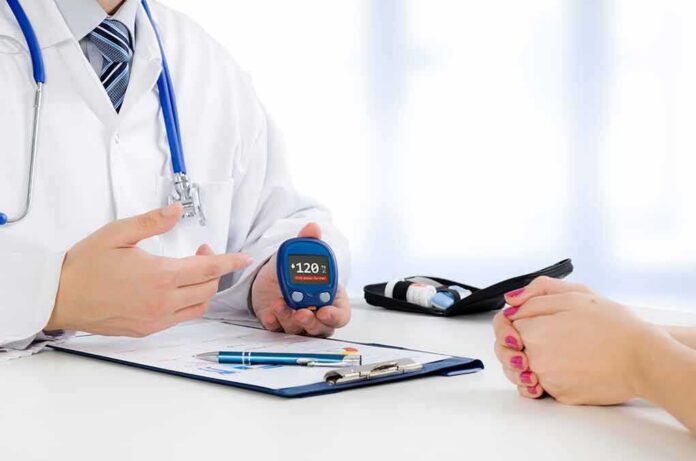 shutterstock_533904595 doctor showing a blood glucose meter to a patient