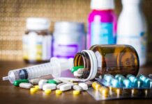 AI Drug Hints At Age Rewind Medicine pills and syringe on table with brown bottle