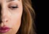 woman's face with a tear on her cheek