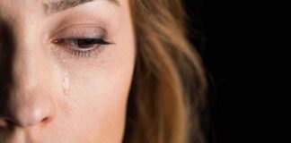woman's face with a tear on her cheek