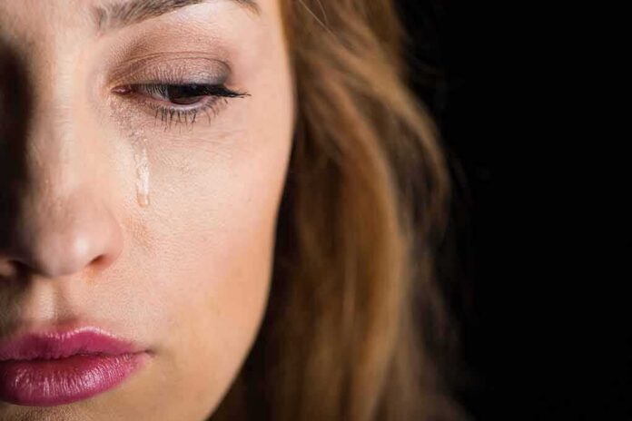 woman's face with a tear on her cheek