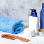 Dentist Warning: The 45-Second Toothbrush Lie bathroom toiletries with blue towel and wooden comb on white surface