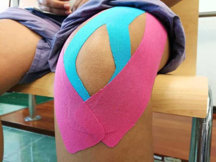 shutterstock_659417128-1 Knee with colorful kinesiology tape applied