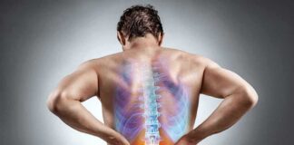 Man holding lower back with highlighted spine illustration