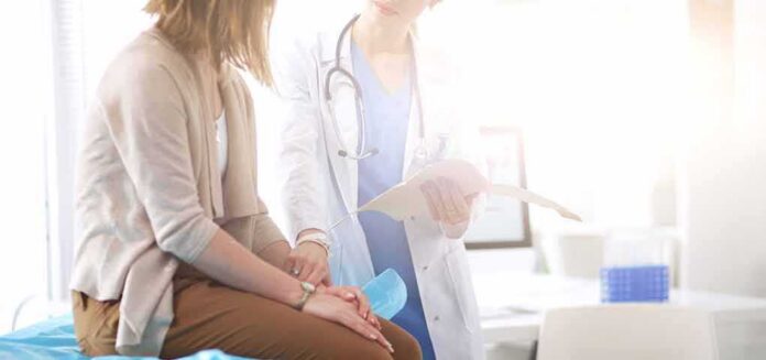 shutterstock_736552108 Doctor consulting with patient in clinic