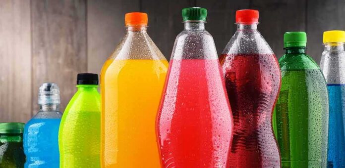 Assorted colorful plastic beverage bottles with condensation