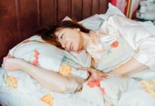 woman lying in bed looking pensive