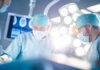 Old Man Disease Ambushing Young Men Surgeons in operating room under bright surgical lights