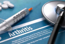 Syringe and stethoscope on arthritis document