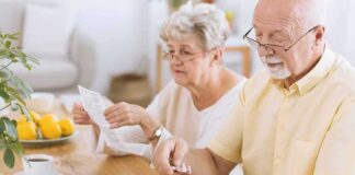 Older couple organizing medication at a kitchen table