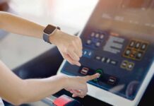 Tiny Workouts With a Massive Brain Edge Person using a treadmill touchscreen with a smartwatch