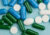Assorted capsules and tablets on a blue background