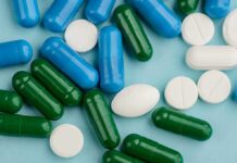 Assorted capsules and tablets on a blue background
