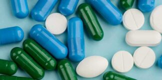 Assorted capsules and tablets on a blue background