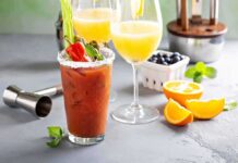 Bloody Mary and mimosas with garnishes on a bar counter