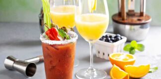 Bloody Mary and mimosas with garnishes on a bar counter