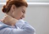 Woman holding her neck in pain