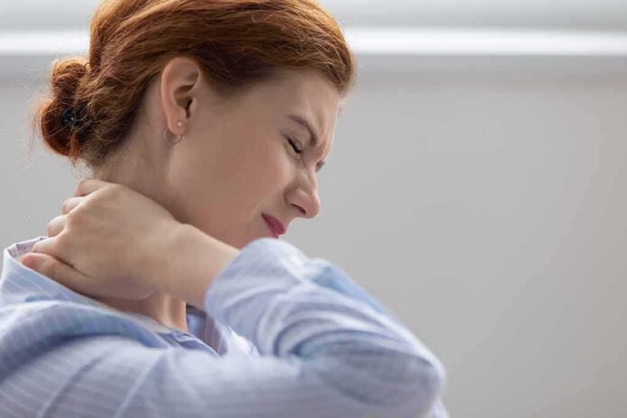 Woman holding her neck in pain