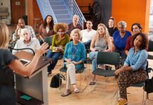 Audience listening to a speaker at a community meeting