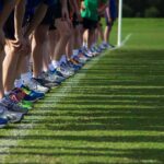 Runners lined up at a starting line on grass