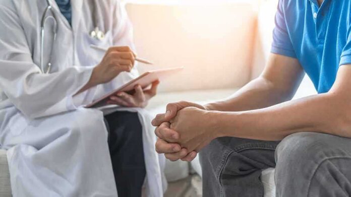 Doctor consulting a patient on a sofa