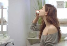 The Best Mouthwash for Bad Breath woman in bathroom using nasal spray
