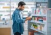 Man shopping in a pharmacy aisle