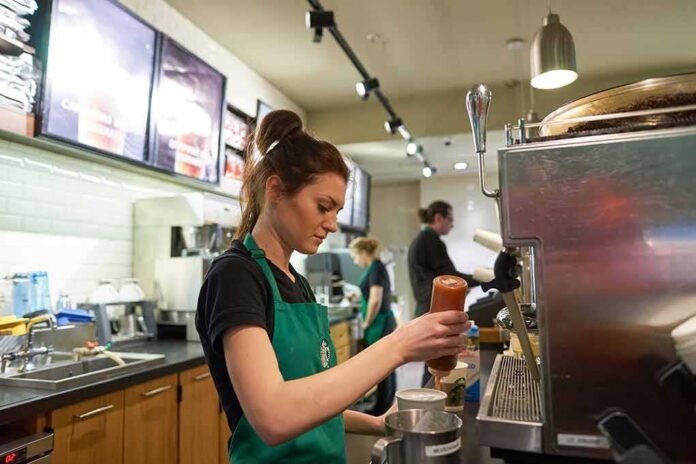 shutterstock_404561860 Barista preparing a drink at a coffee shop counter