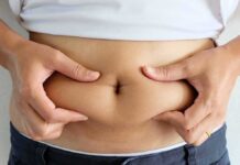 Simple Habits That Crush Deadly Visceral Fat person pinching belly fat at the waist