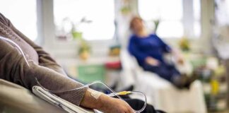 Patient arm with IV line in a hospital chair