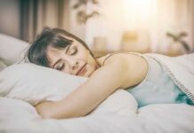 Weekend Sleep-In Drops Depression Risk Woman sleeping on a bed