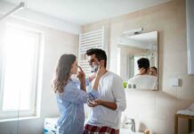 Couple in bathroom applying shaving cream playfully