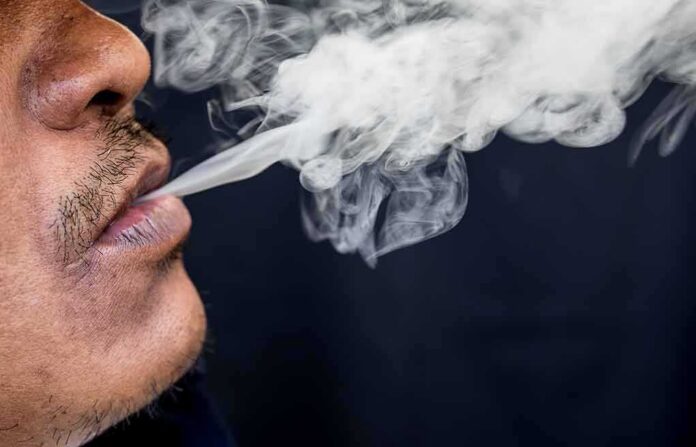 shutterstock_668061646 Close-up of a person exhaling smoke